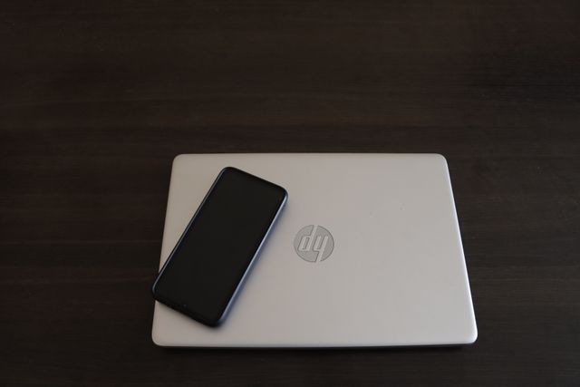a laptop and phone on a table