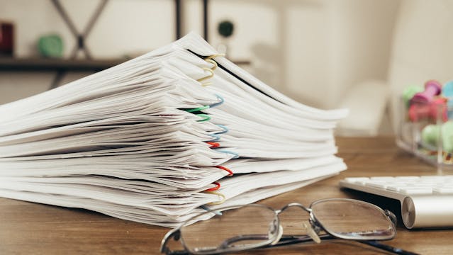 a stack of papers on a desk